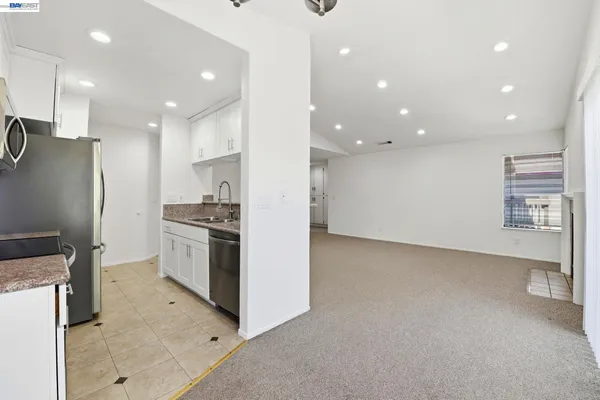 a kitchen with stainless steel appliances a stove microwave and refrigerator