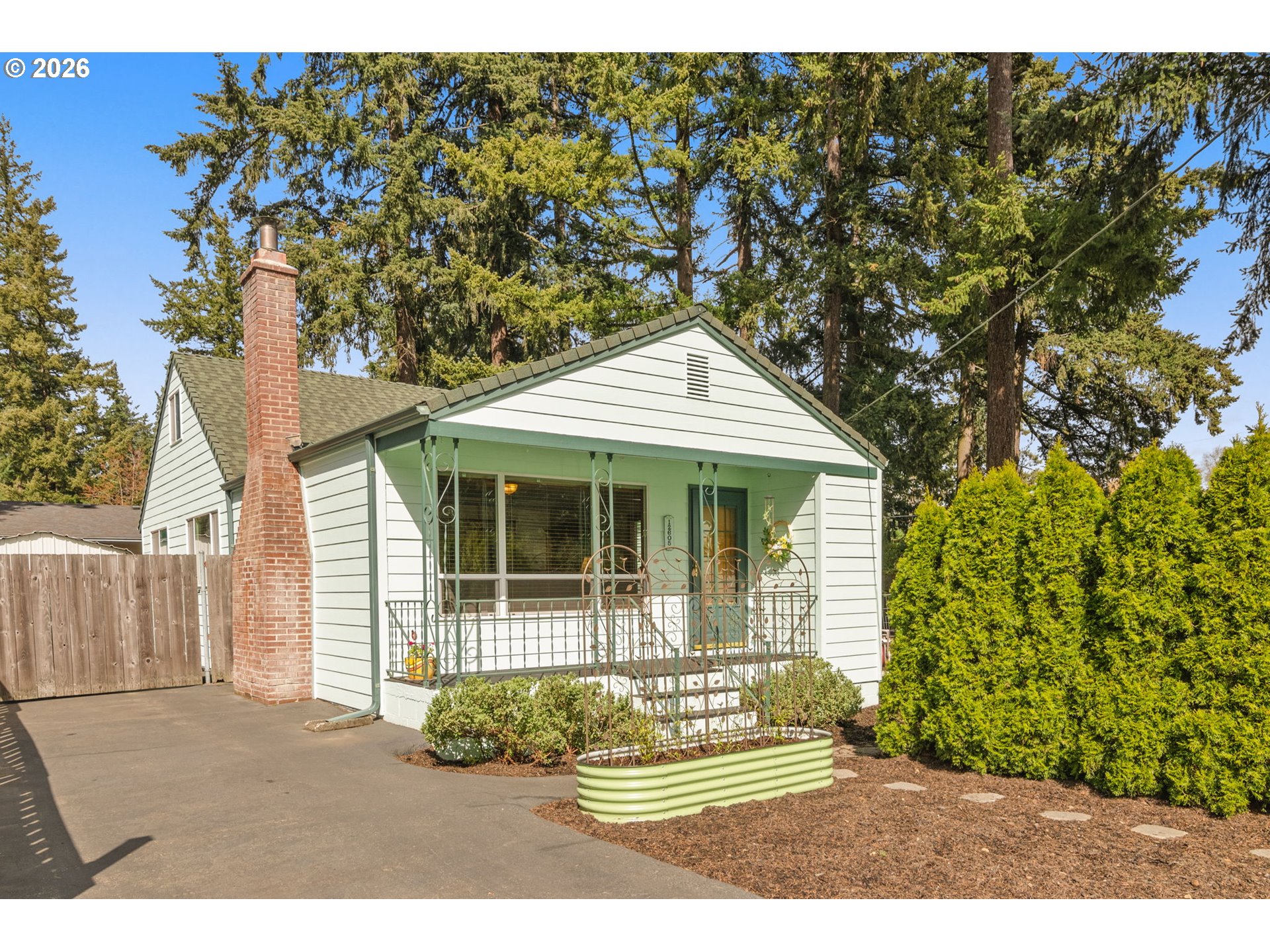 12605 Southeast Holgate Boulevard Portland, OR 97236 - Photo 1 of 43 a front view of a house with garden