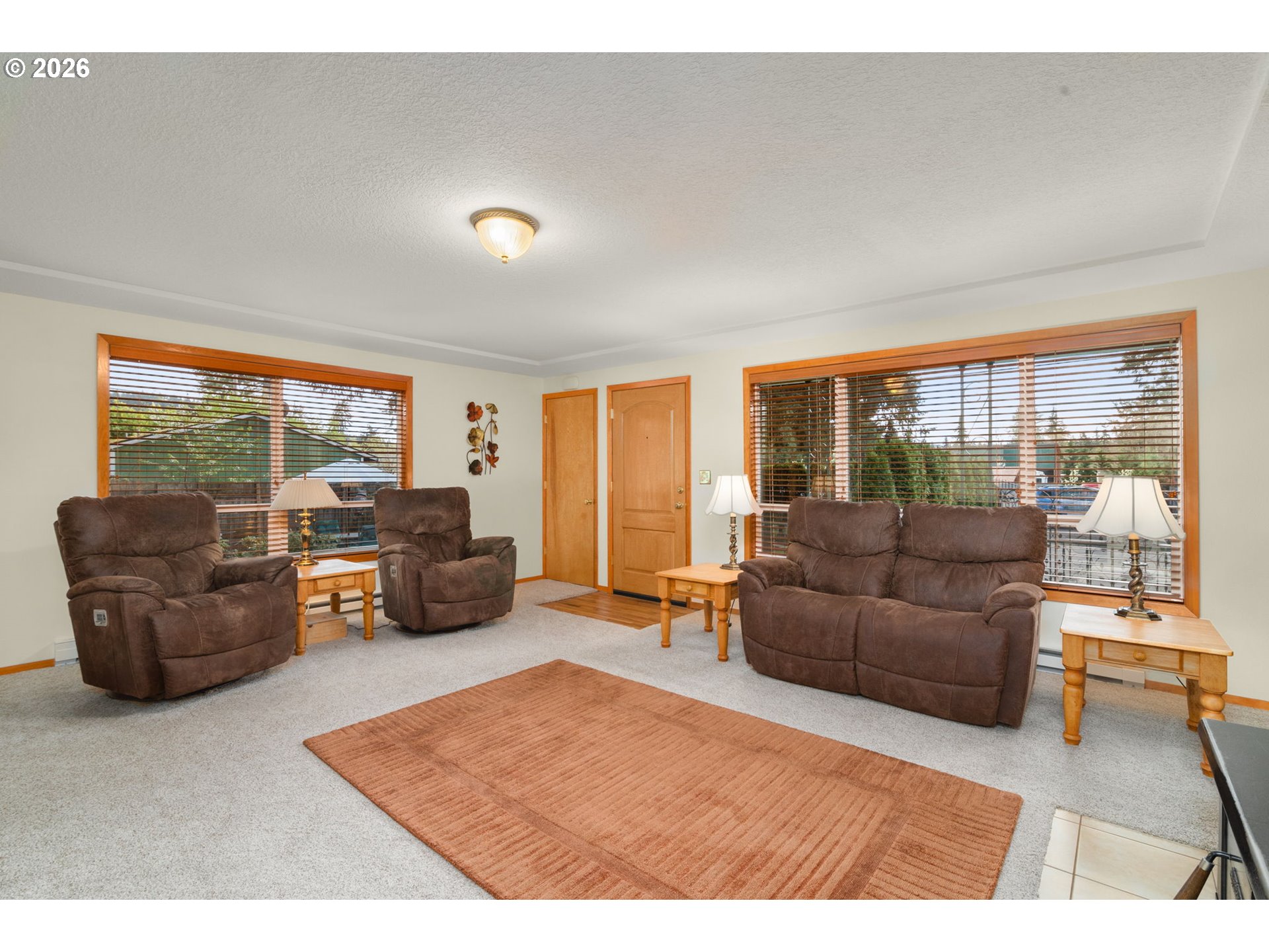 12605 Southeast Holgate Boulevard Portland, OR 97236 - Photo 11 of 43 a living room with furniture and large windows