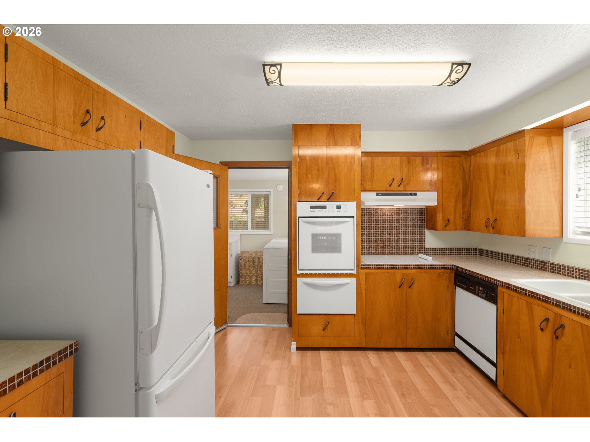 12605 Southeast Holgate Boulevard Portland, OR 97236 - Photo 13 of 43 a kitchen with stainless steel appliances a refrigerator and a sink