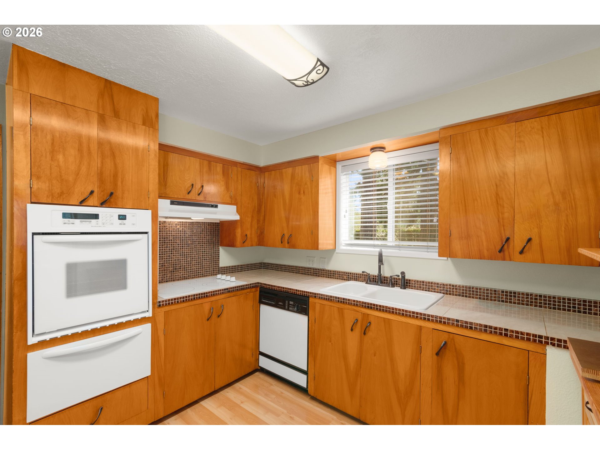12605 Southeast Holgate Boulevard Portland, OR 97236 - Photo 14 of 43 a kitchen with a sink and a refrigerator
