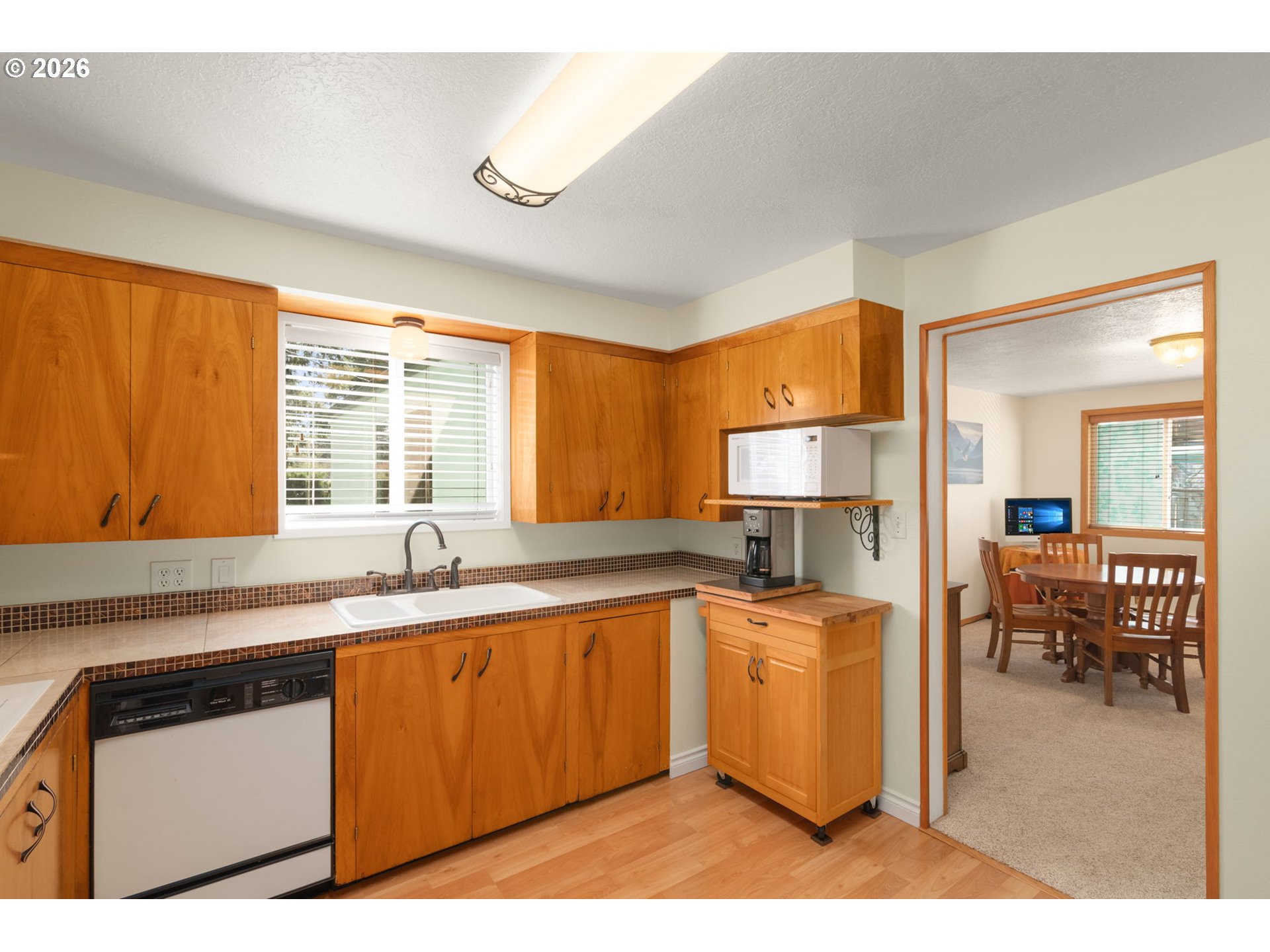 12605 Southeast Holgate Boulevard Portland, OR 97236 - Photo 15 of 43 a kitchen with stainless steel appliances granite countertop a sink and cabinets