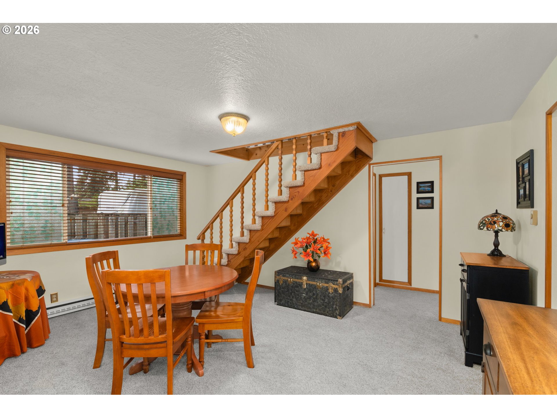 12605 Southeast Holgate Boulevard Portland, OR 97236 - Photo 17 of 43 a dining room with furniture and a floor to ceiling window