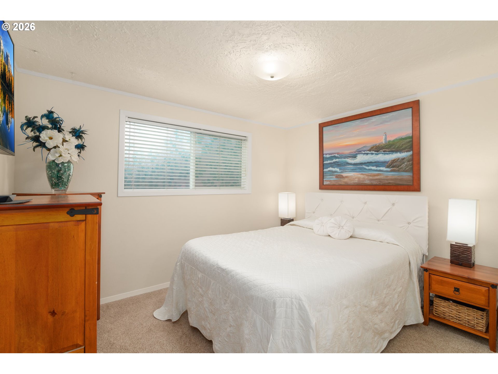 12605 Southeast Holgate Boulevard Portland, OR 97236 - Photo 19 of 43 a bedroom with a bed and a painting on the wall