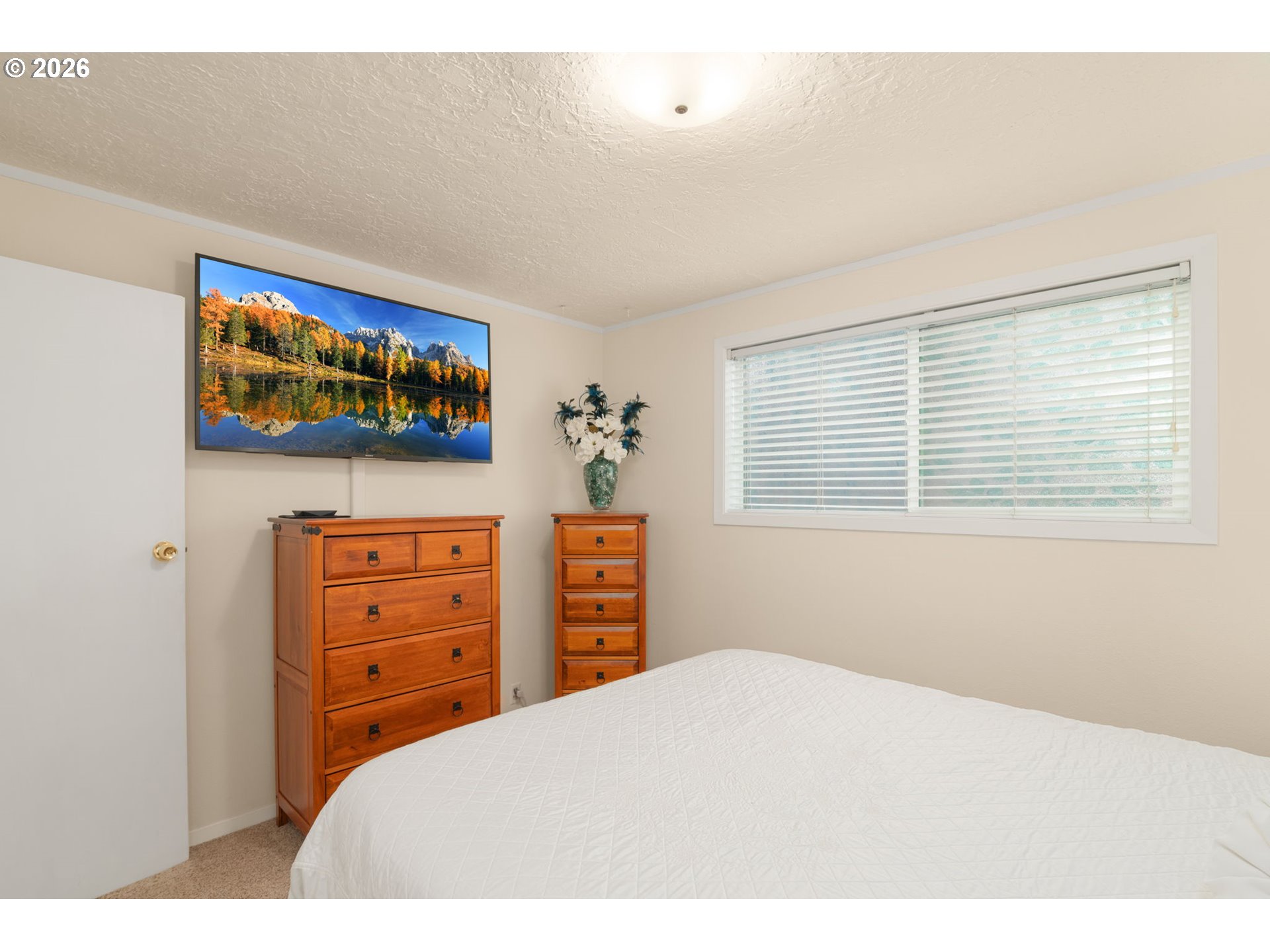 12605 Southeast Holgate Boulevard Portland, OR 97236 - Photo 20 of 43 a bedroom with a bed and a flat screen tv