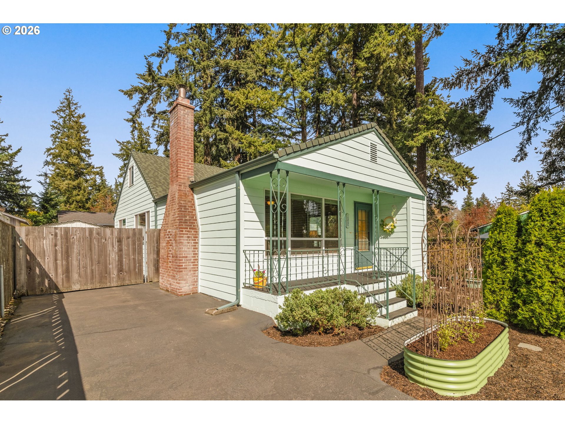 12605 Southeast Holgate Boulevard Portland, OR 97236 - Photo 3 of 43 a front view of a house with a garden