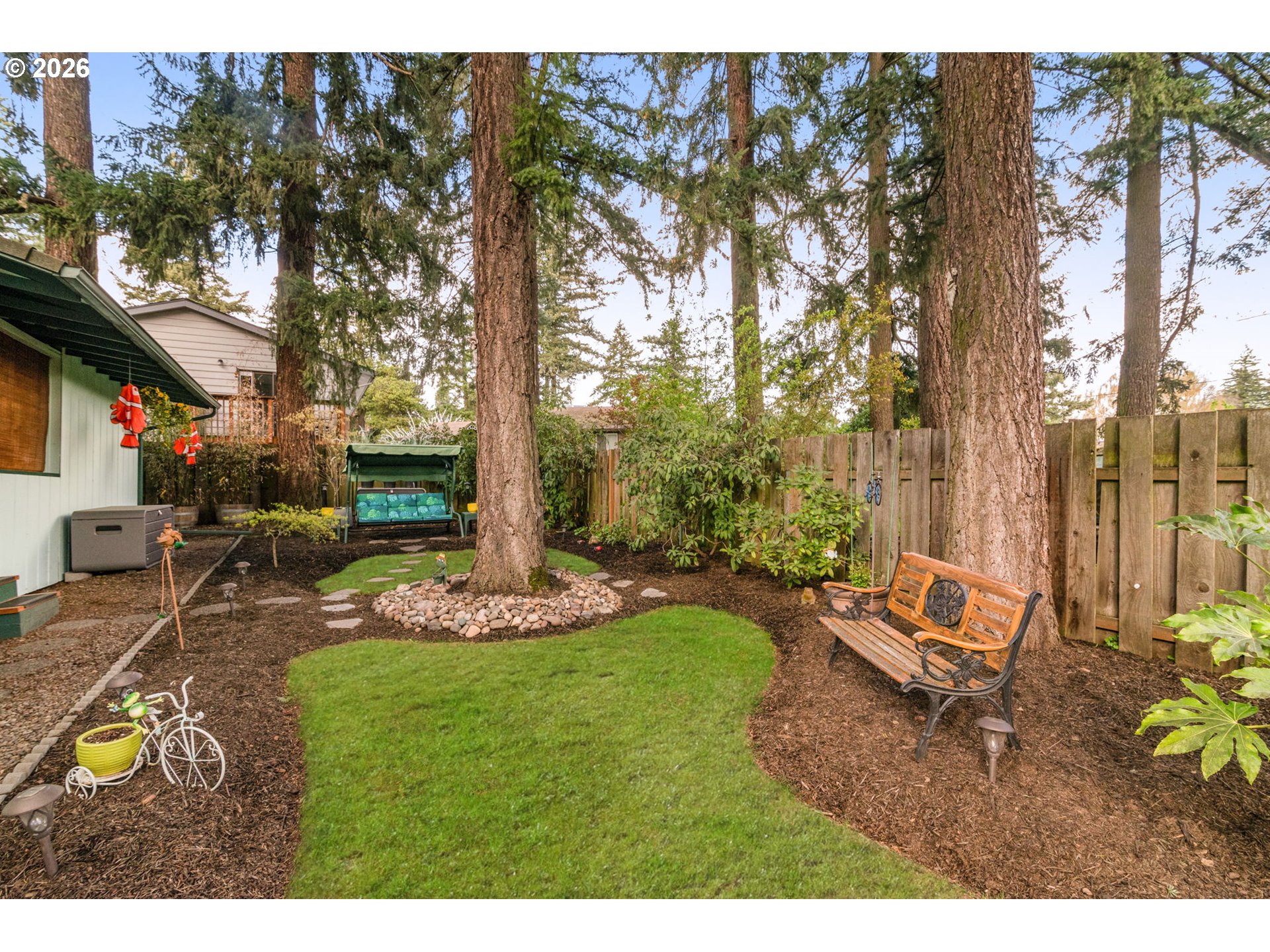 12605 Southeast Holgate Boulevard Portland, OR 97236 - Photo 36 of 43 a backyard of a house with yard table and chairs
