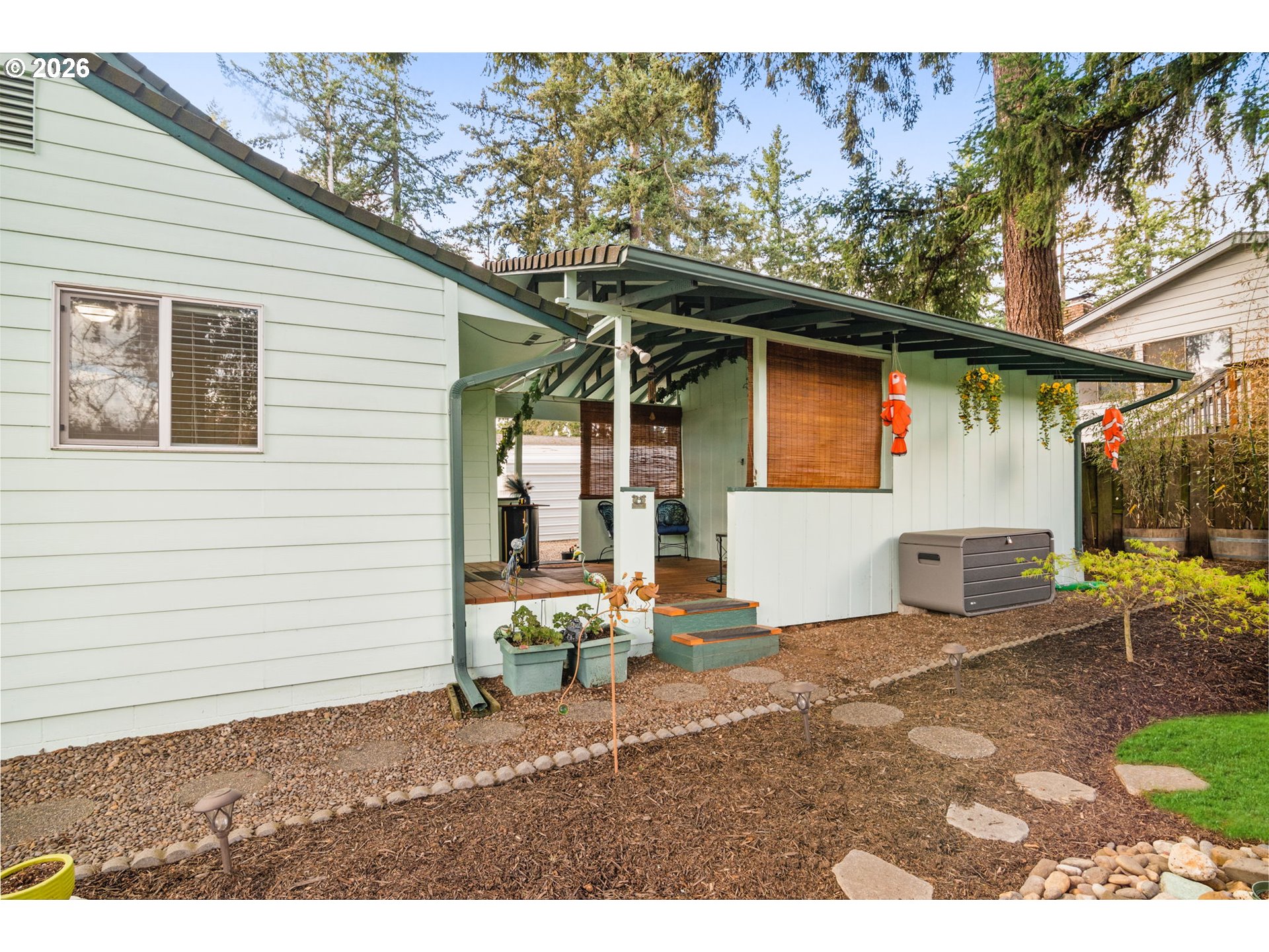12605 Southeast Holgate Boulevard Portland, OR 97236 - Photo 38 of 43 a backyard of a house with table and chairs