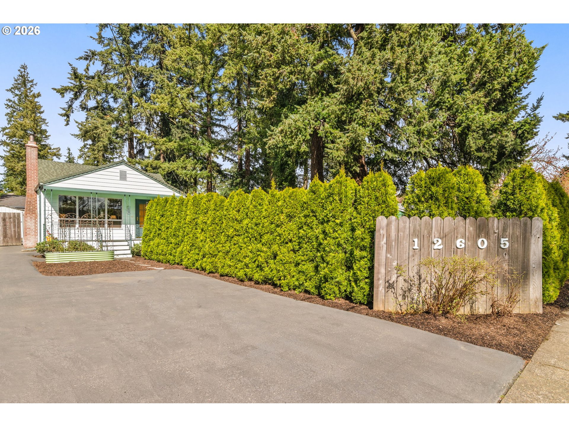 12605 Southeast Holgate Boulevard Portland, OR 97236 - Photo 41 of 43 a front view of a house with a yard