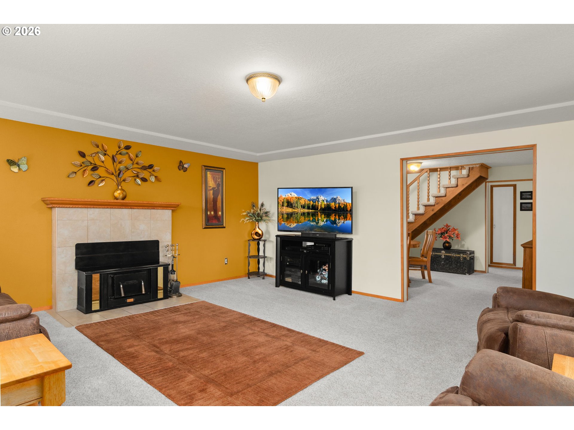 12605 Southeast Holgate Boulevard Portland, OR 97236 - Photo 8 of 43 a living room with furniture and a fireplace