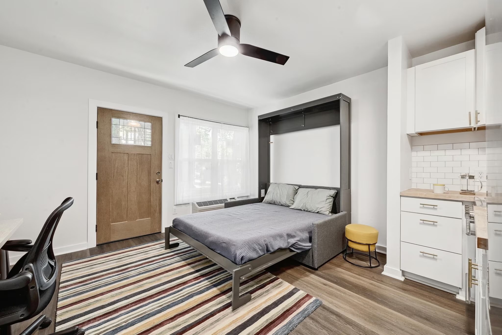 2802 Whitis Avenue, Unit 106 Austin, TX 78705 - Photo 4 of 8 Compact living area featuring wood-finish flooring and a ceiling fan