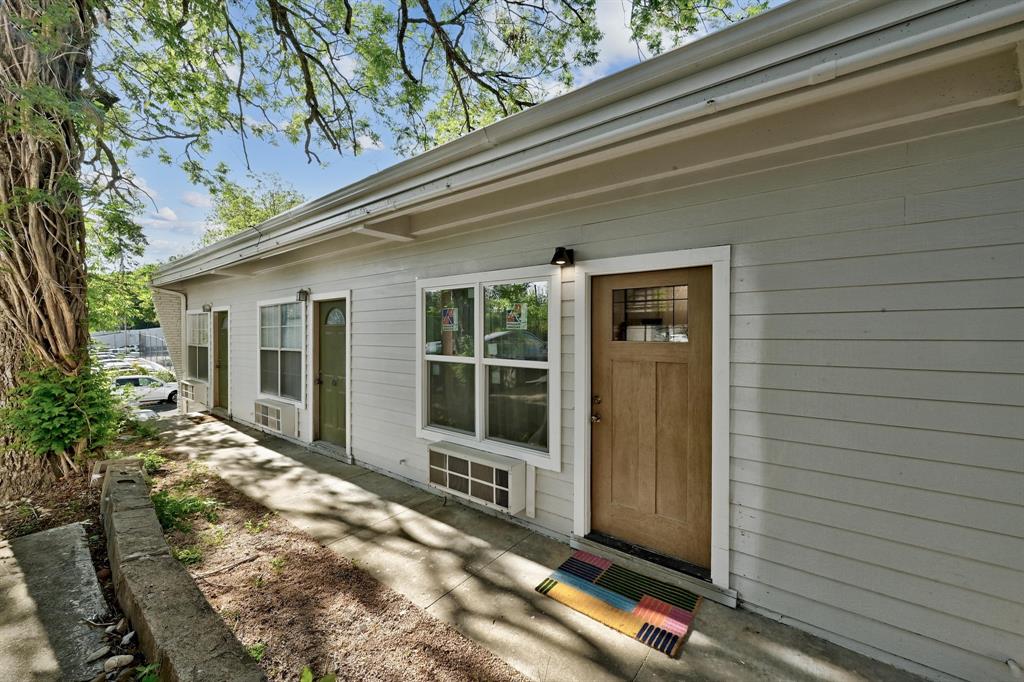 2802 Whitis Avenue, Unit 106 Austin, TX 78705 - Photo 8 of 8 Light grey horizontal siding exterior featuring multiple entry points