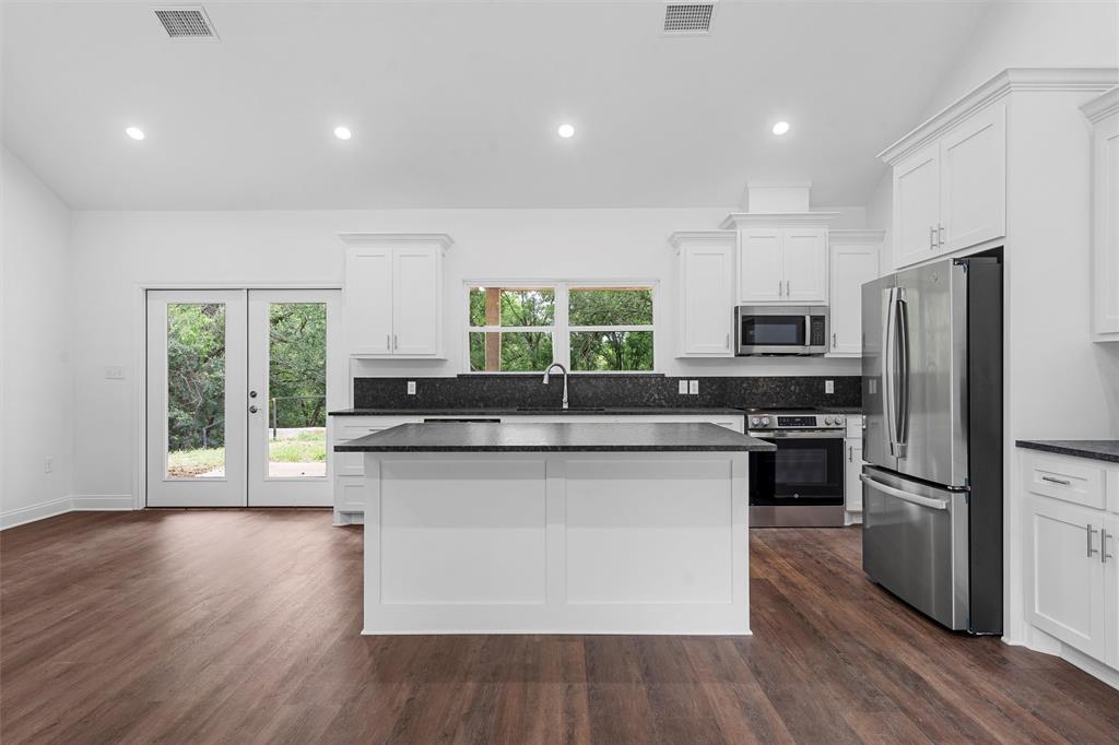 1698 Rogers Hill Road Waco, TX 76705 - Photo 8 of 40 Kitchen with appliances with stainless steel finishes, dark countertops, white cabinetry, and recessed lighting