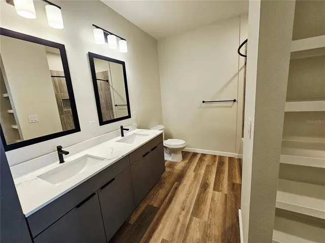 a bathroom with 2 sink and a mirror