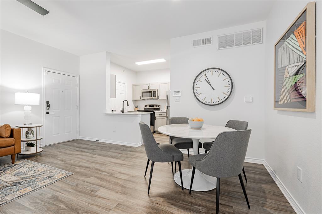 1600 North 9th Street, Unit A1R Midlothian, TX 76065 - Photo 12 of 15 a view of a dining area with furniture and a clock