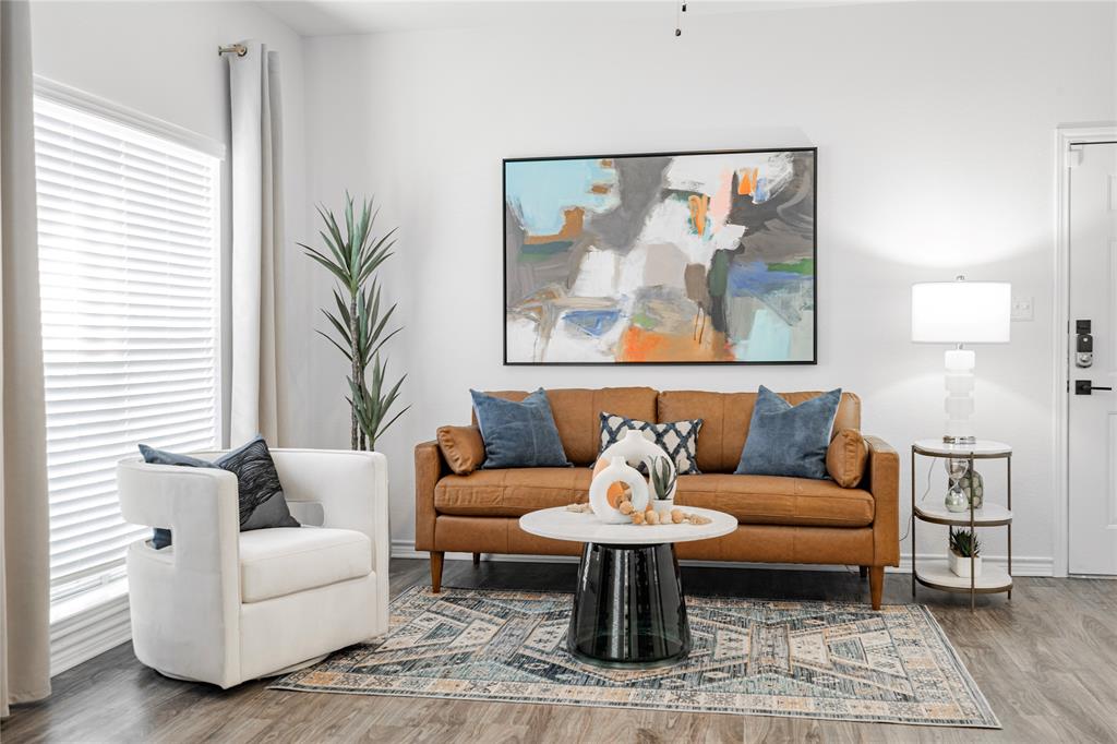 1600 North 9th Street, Unit A1R Midlothian, TX 76065 - Photo 10 of 15 a living room with furniture a rug and a painting on the wall