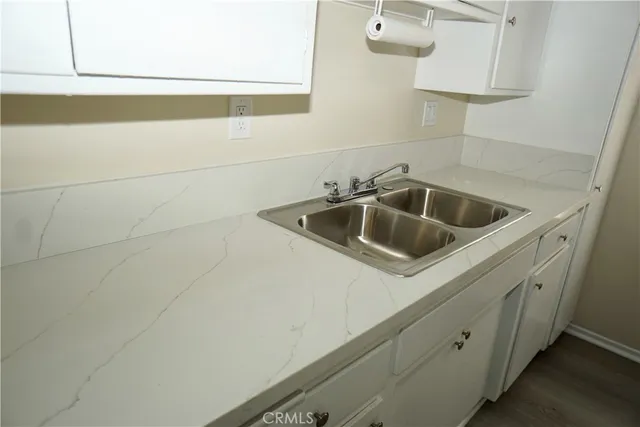 a kitchen with a sink and cabinets