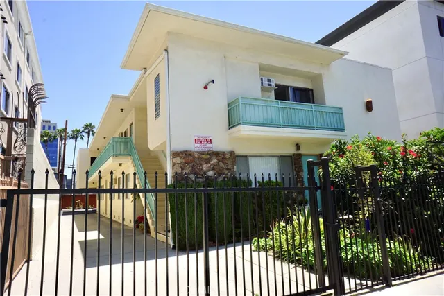 a view of a house with a small yard and plants