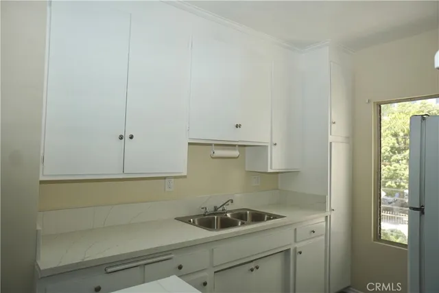 a kitchen with a sink and cabinets