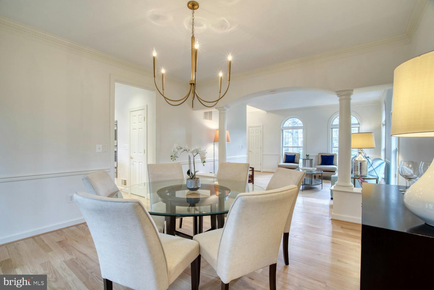 1702 South Arlington Ridge Road Arlington, VA 22202 - Photo 15 of 49 a dining room with furniture a chandelier and wooden floor