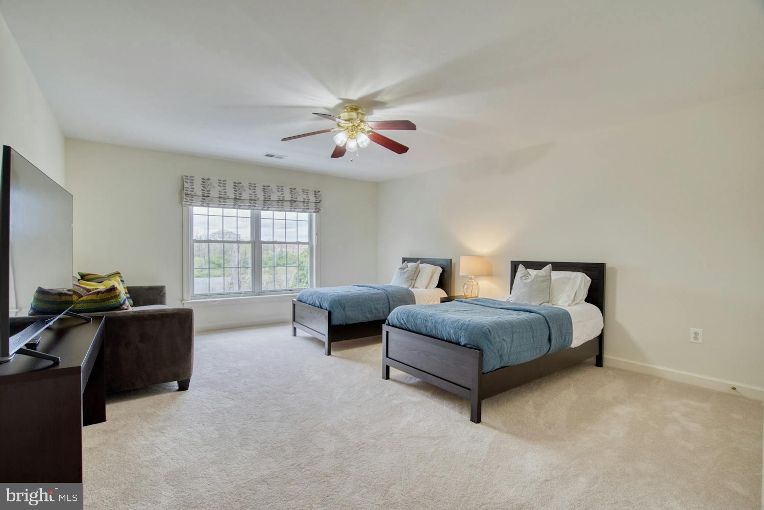 1702 South Arlington Ridge Road Arlington, VA 22202 - Photo 29 of 49 a spacious bedroom with a bed and a chandelier