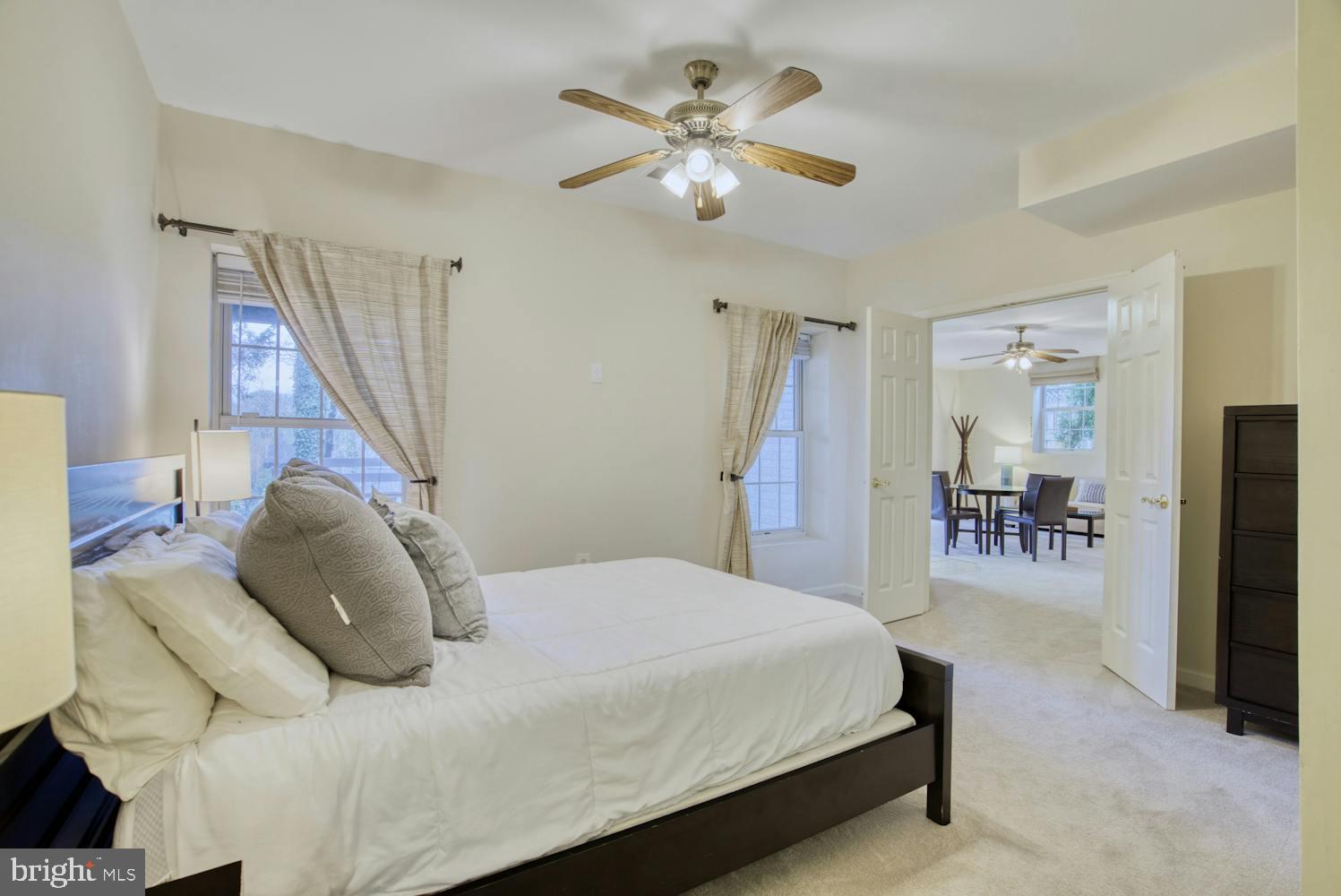 1702 South Arlington Ridge Road Arlington, VA 22202 - Photo 42 of 49 a bedroom with a bed and a chandelier