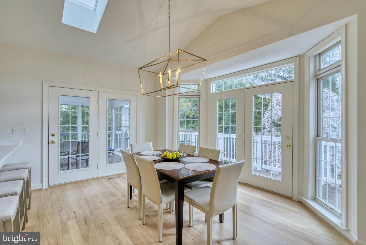 1702 South Arlington Ridge Road Arlington, VA 22202 - Photo 8 of 49 a view of a dining room with furniture large windows and wooden floor