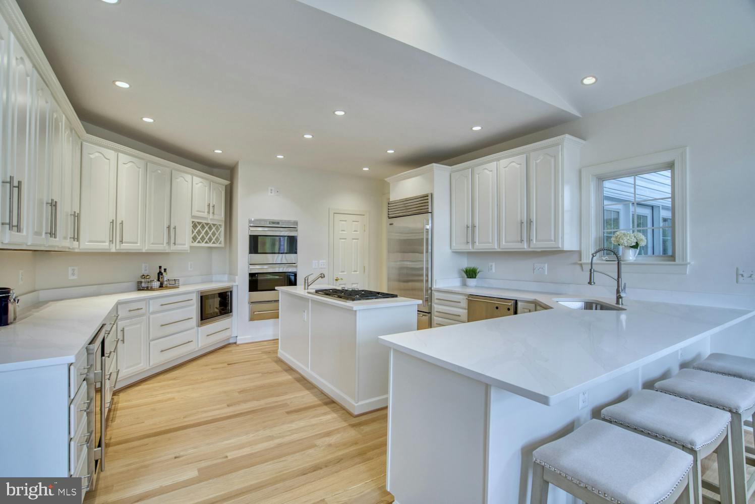 1702 South Arlington Ridge Road Arlington, VA 22202 - Photo 9 of 49 a kitchen with a sink a counter top space stainless steel appliances and cabinets