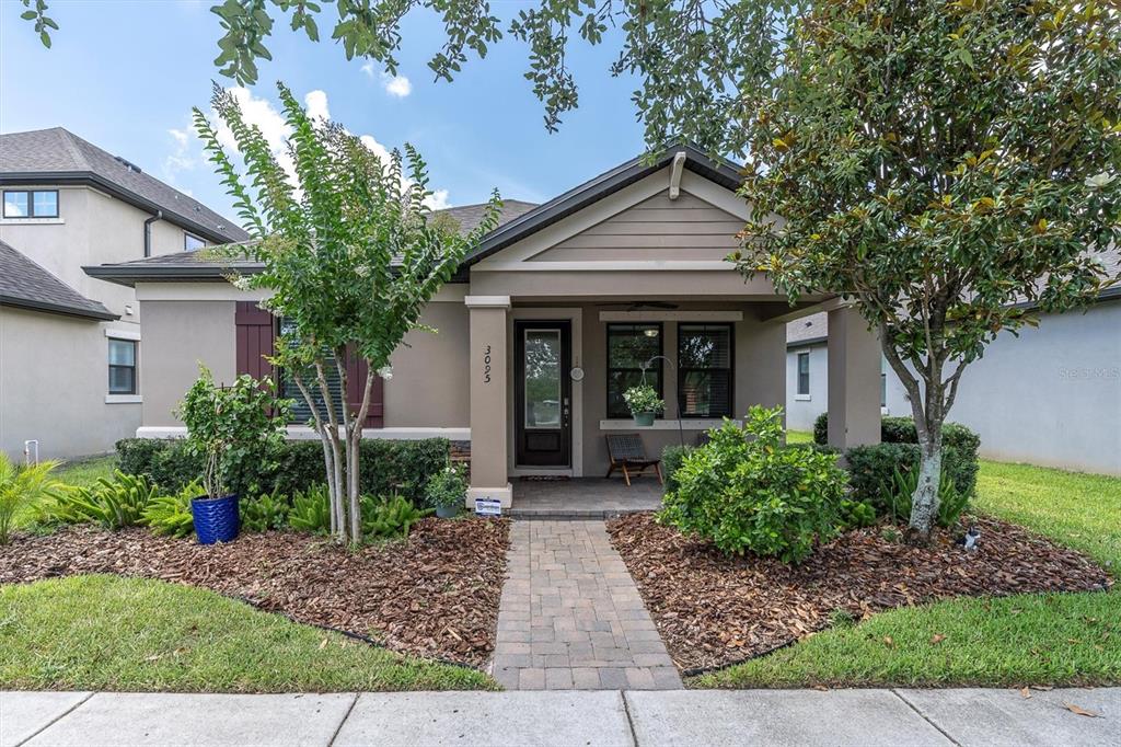 a front view of house with a garden