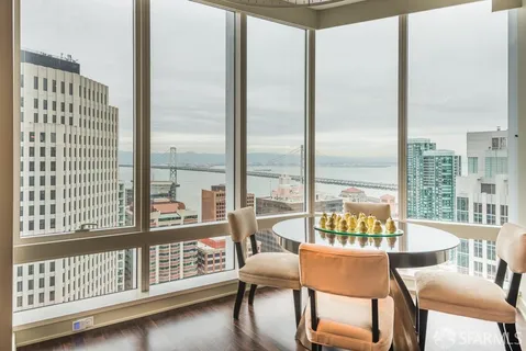 a dining room with furniture and a floor to ceiling window
