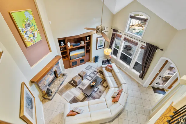 a living room with stainless steel appliances kitchen island granite countertop a stove and cabinets