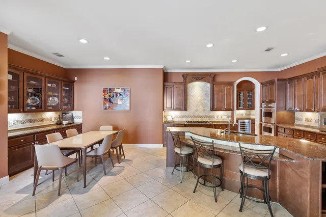 a kitchen with stainless steel appliances granite countertop sink stove and refrigerator