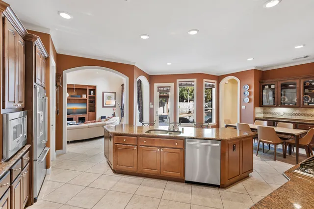 a kitchen with stainless steel appliances granite countertop a stove and refrigerator