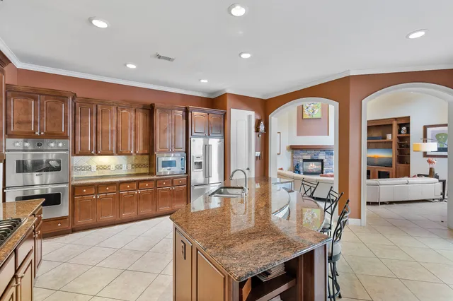 a dining room with furniture a chandelier and wooden floor