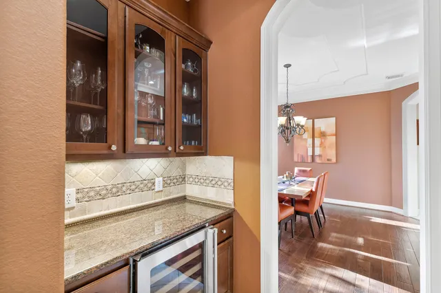 a view of a dining room with furniture wooden floor and chandelier