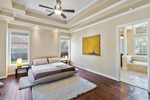 a bathroom with a glass shower door and a window