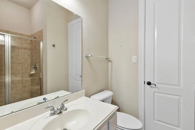 a view of a hallway with a livingroom and stairs