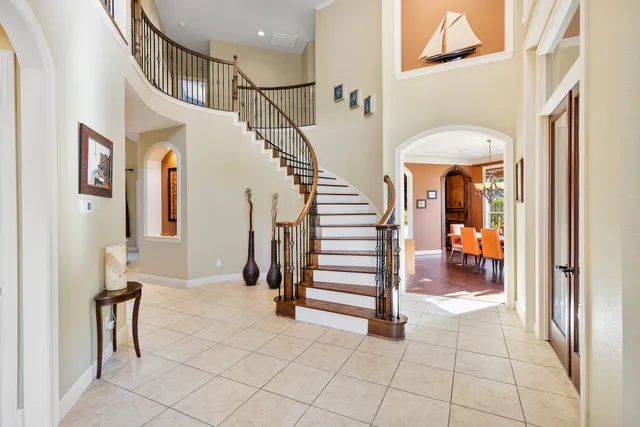 a view of staircase with lots of frames and chairs