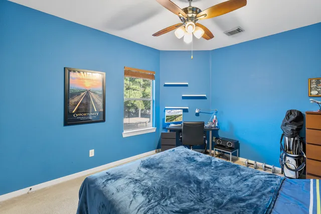 a view of a big house with a big yard and large trees