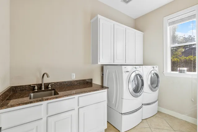 a living room with furniture a rug and white walls