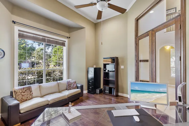 a living room with furniture a fireplace and a flat screen tv
