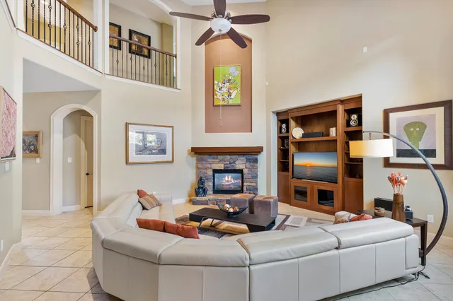 a living room with furniture fireplace and flat screen tv