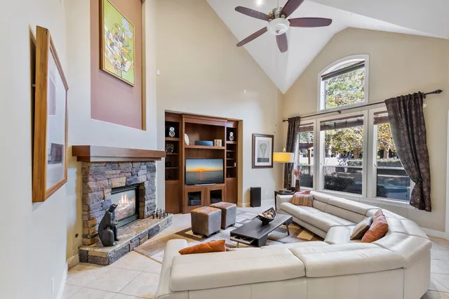 a living room with furniture a fireplace and a table