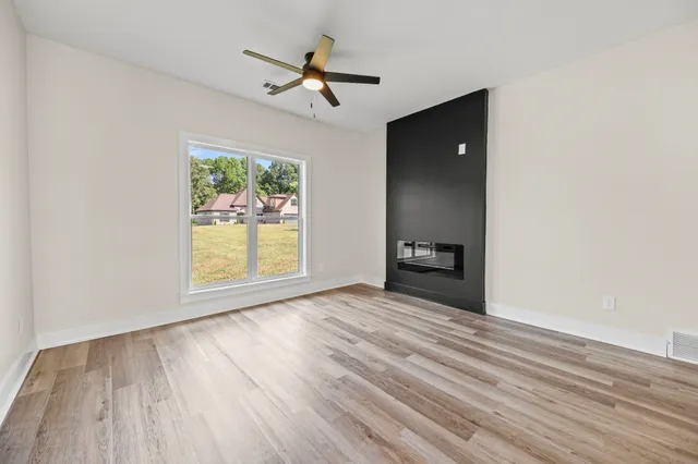 a kitchen with kitchen island granite countertop a sink stove and refrigerator
