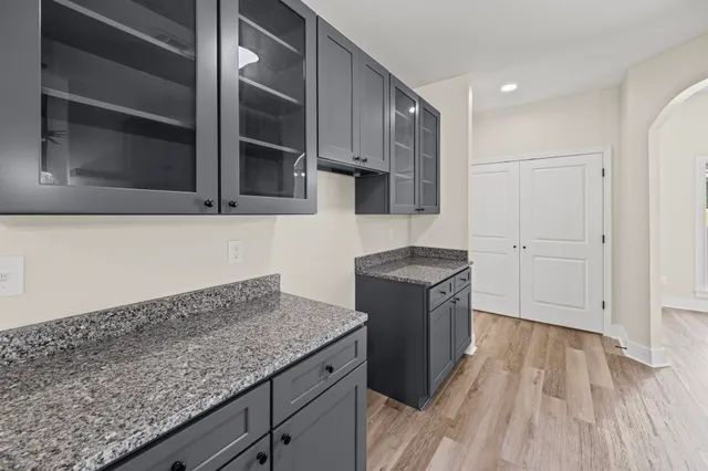 a kitchen with a sink stove and cabinets
