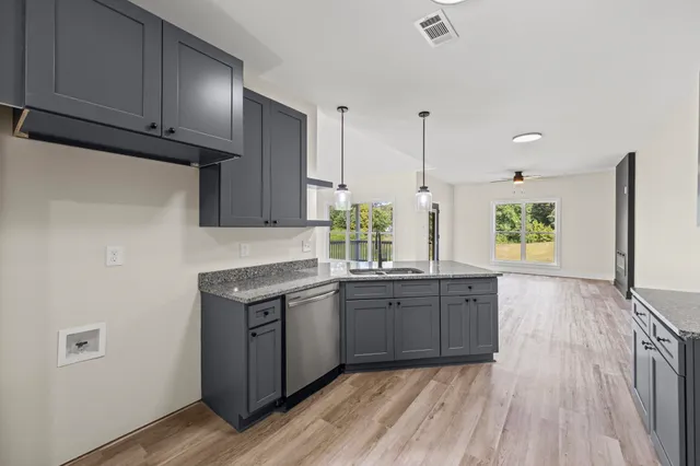a bathroom with a granite countertop sink a mirror and shower