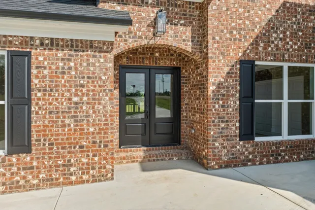 a view of a hallway view with wooden floor and staircase