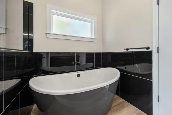 a white bath tub sitting next to a bathroom