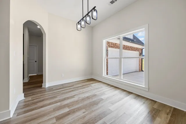 a view of a room with wooden floor window and a ceiling fan