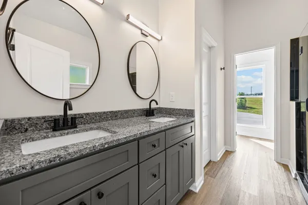 a bathroom with a granite countertop sink and a mirror